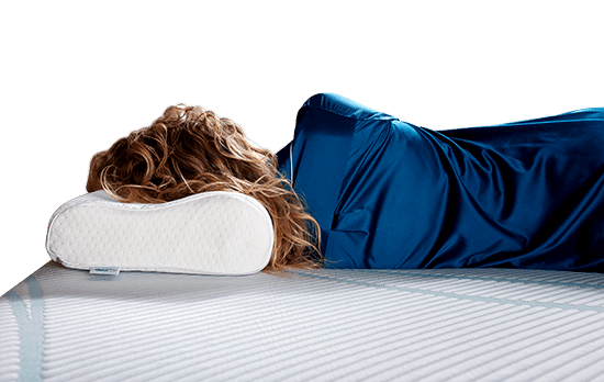 a woman laying on the Tempur Neck pillow on a Tempur-Pedic mattress