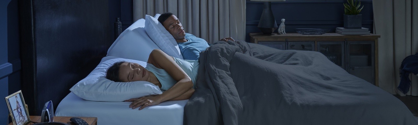 Couple asleep on a Tempur-Pedic adjustable base.