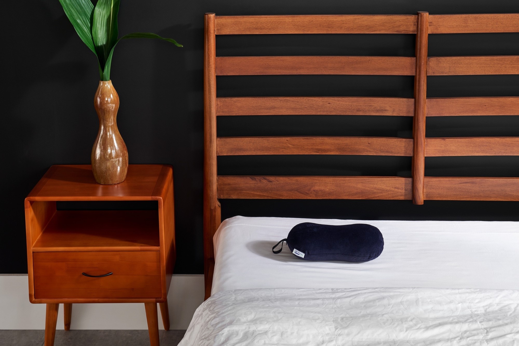 All-Purpose Pillow on corner of bed in styled room