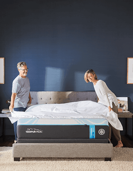 a couple putting sheets on their mattress mobile